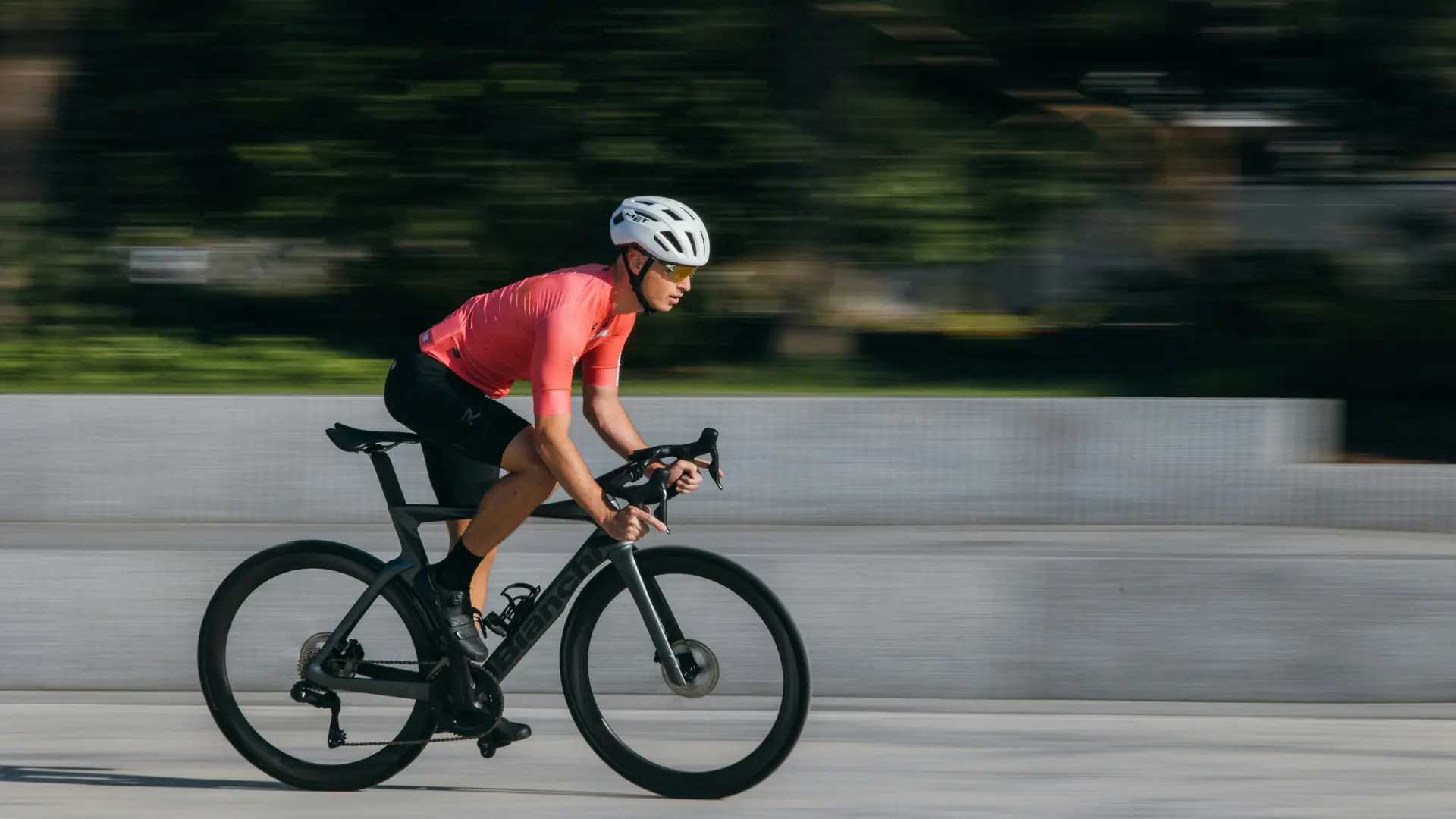 Road cyclist in a helmet riding on an open road